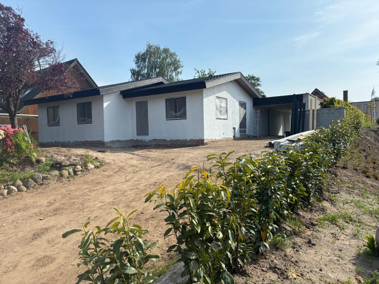 Villaen undervejs — pudset, hvid facade og nyt sort tag
